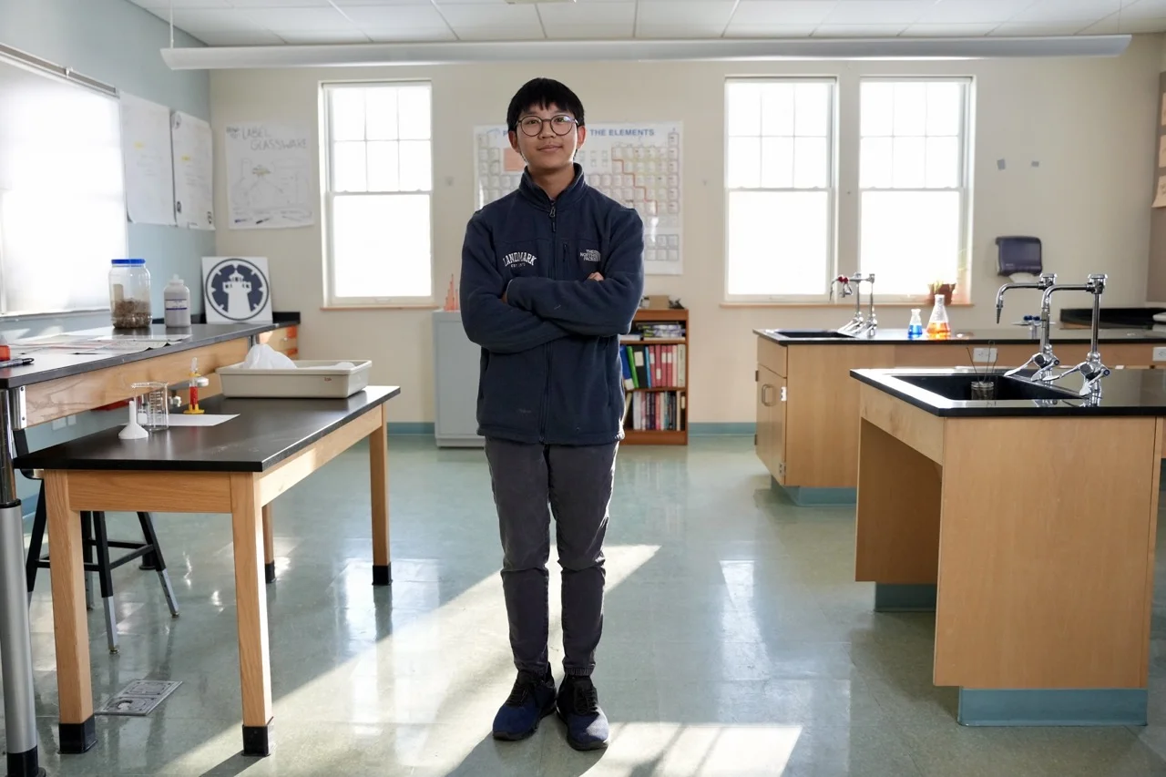 boy standing in science classroom